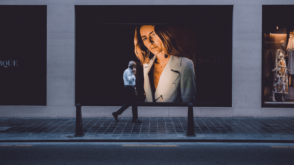 customer walking past a OOH billboard